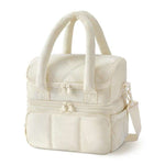 Double-layer insulated quilted pufferfish lunch bag in pink with curved shoulder straps and patchwork design