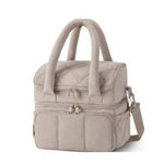 Double-layer insulated quilted pufferfish lunch bag with curved shoulder straps in pink, off-white, and black colors